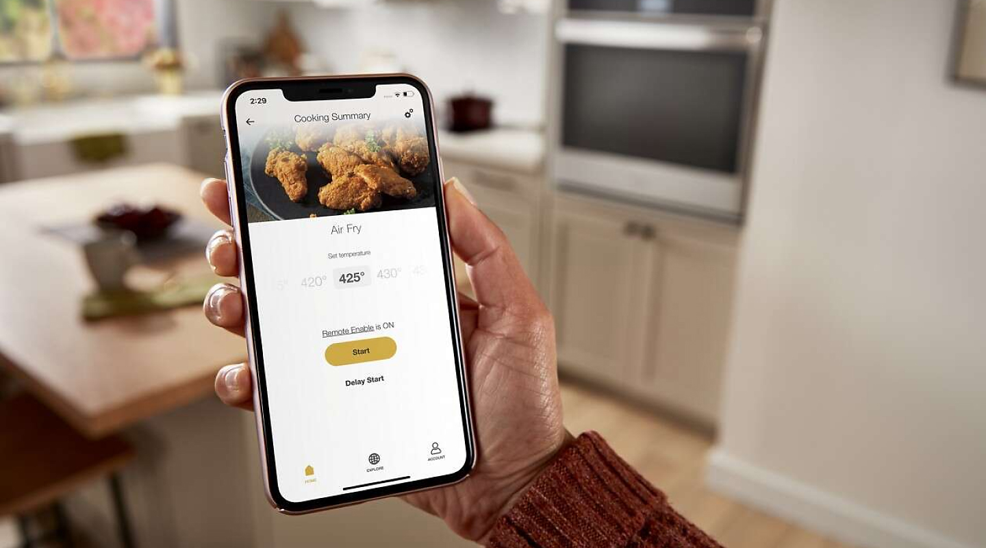 A closeup of a person holding a phone showing an online air fry recipe.