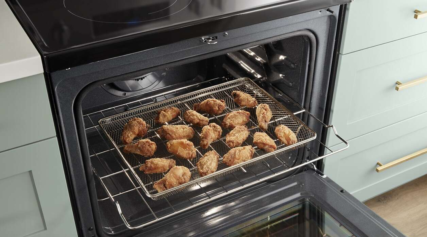 A closeup of a Whirlpool® oven with air fried food.