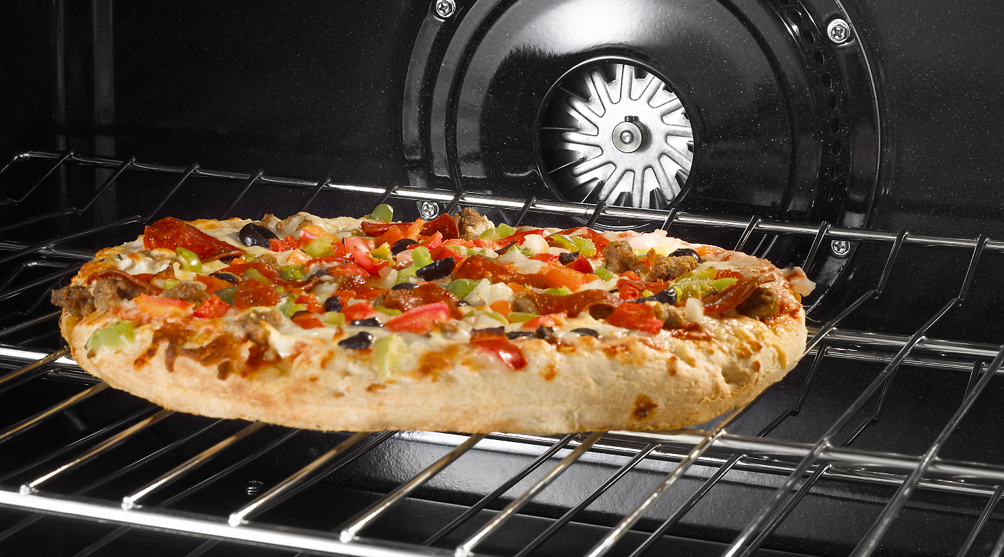 Pizza inside oven on rack.