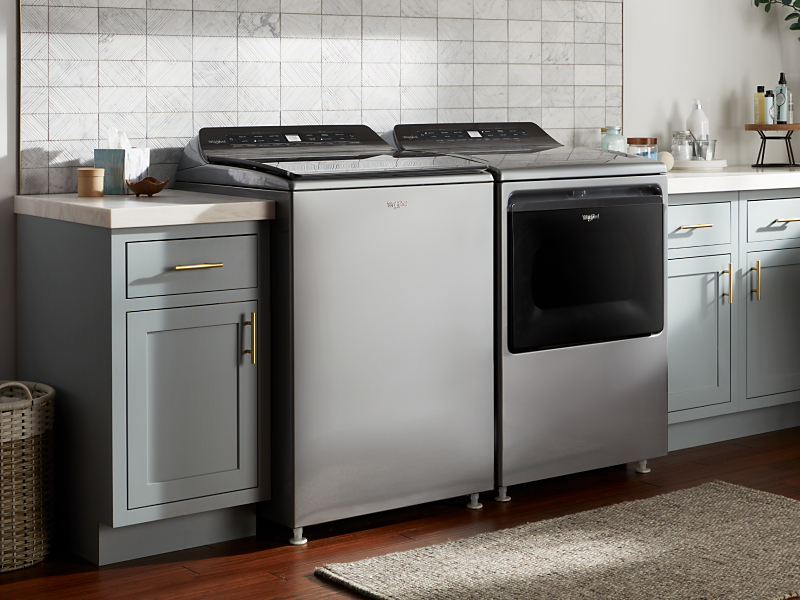Whirlpool® top-load washer and dryer in a laundry room
