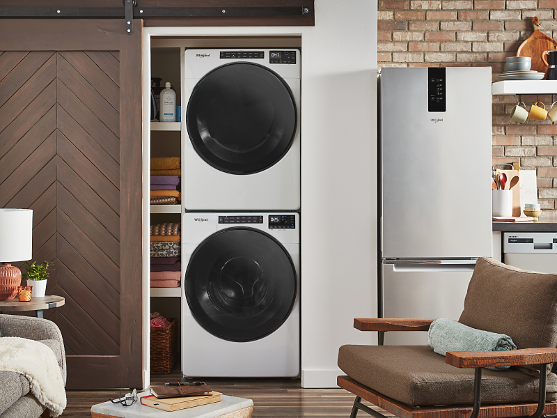 White Whirlpool® stacked washer and dryer unit inside a closet