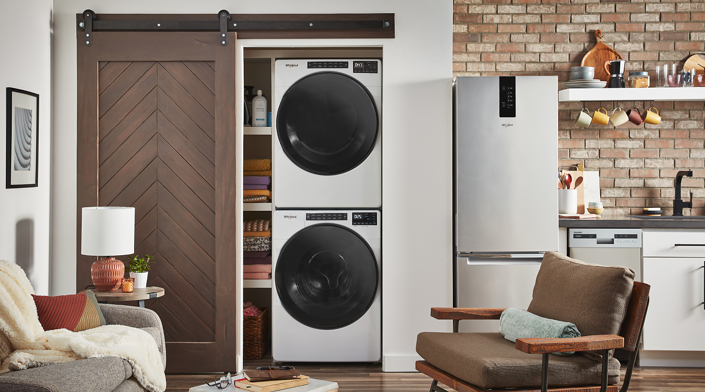White Whirlpool® stacked washer and dryer unit inside a closet