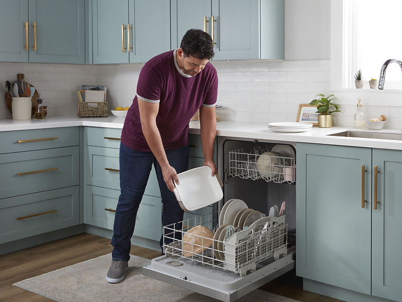 Person loading dishes into a dishwasher