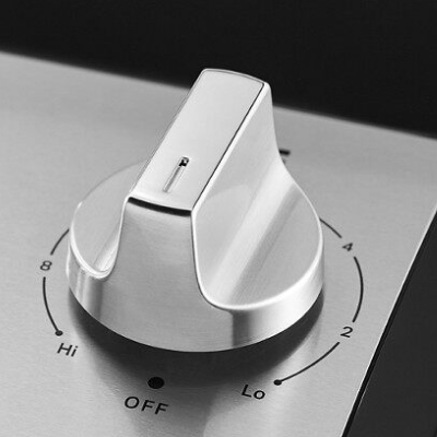 Close-up of stainless steel electric stovetop knob