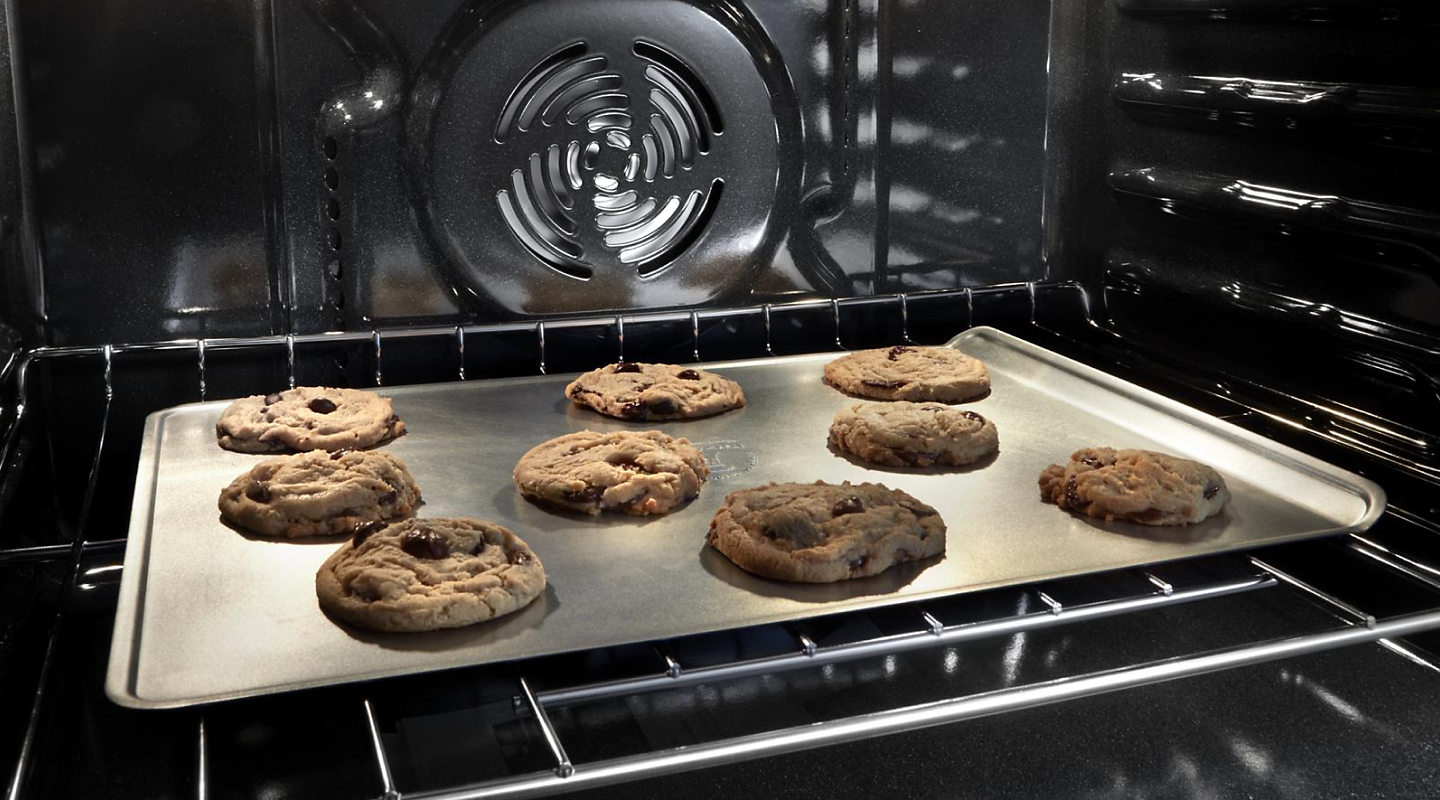 Chocolate chip cookies baking in an oven