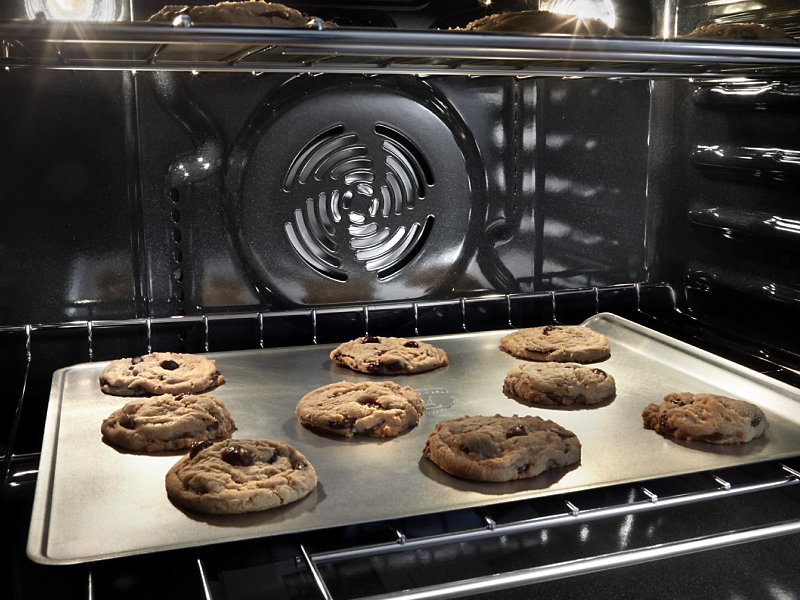 Chocolate chip cookies baking in an oven