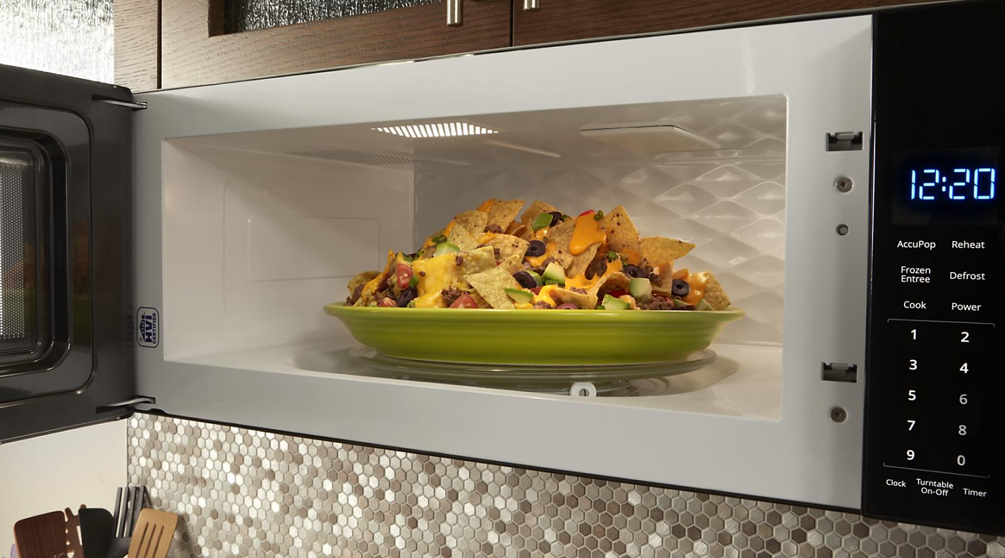 Plate of nachos inside a built-in microwave