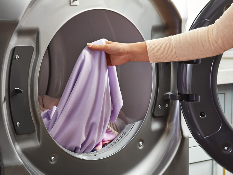 Purple silk clothing item in a dryer.