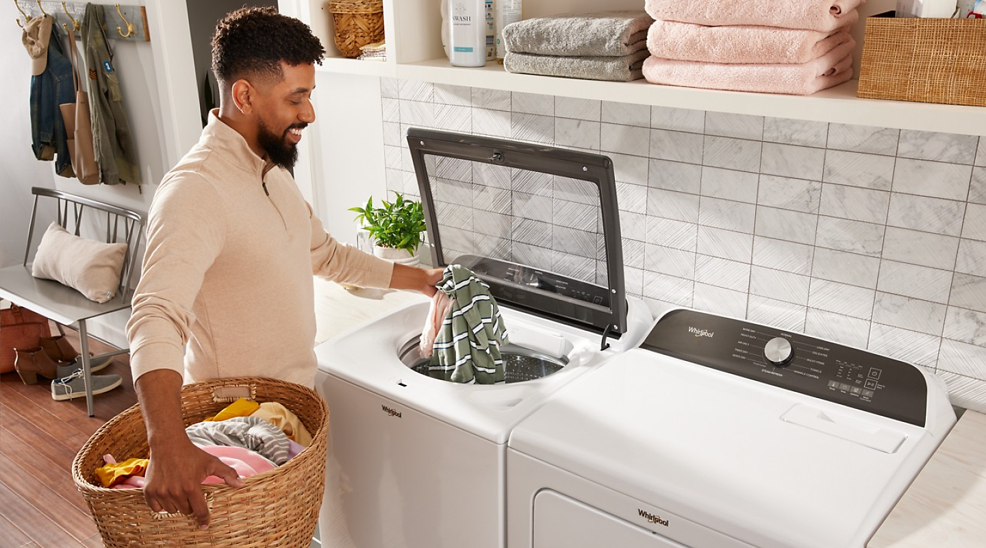Person putting clothing into Whirlpool® washer