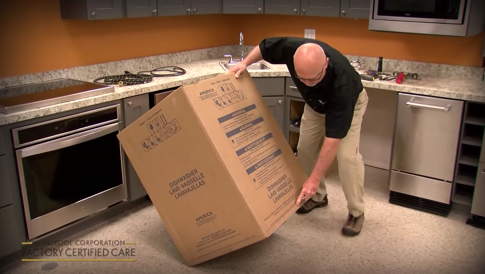 Person moving a packaged dishwasher