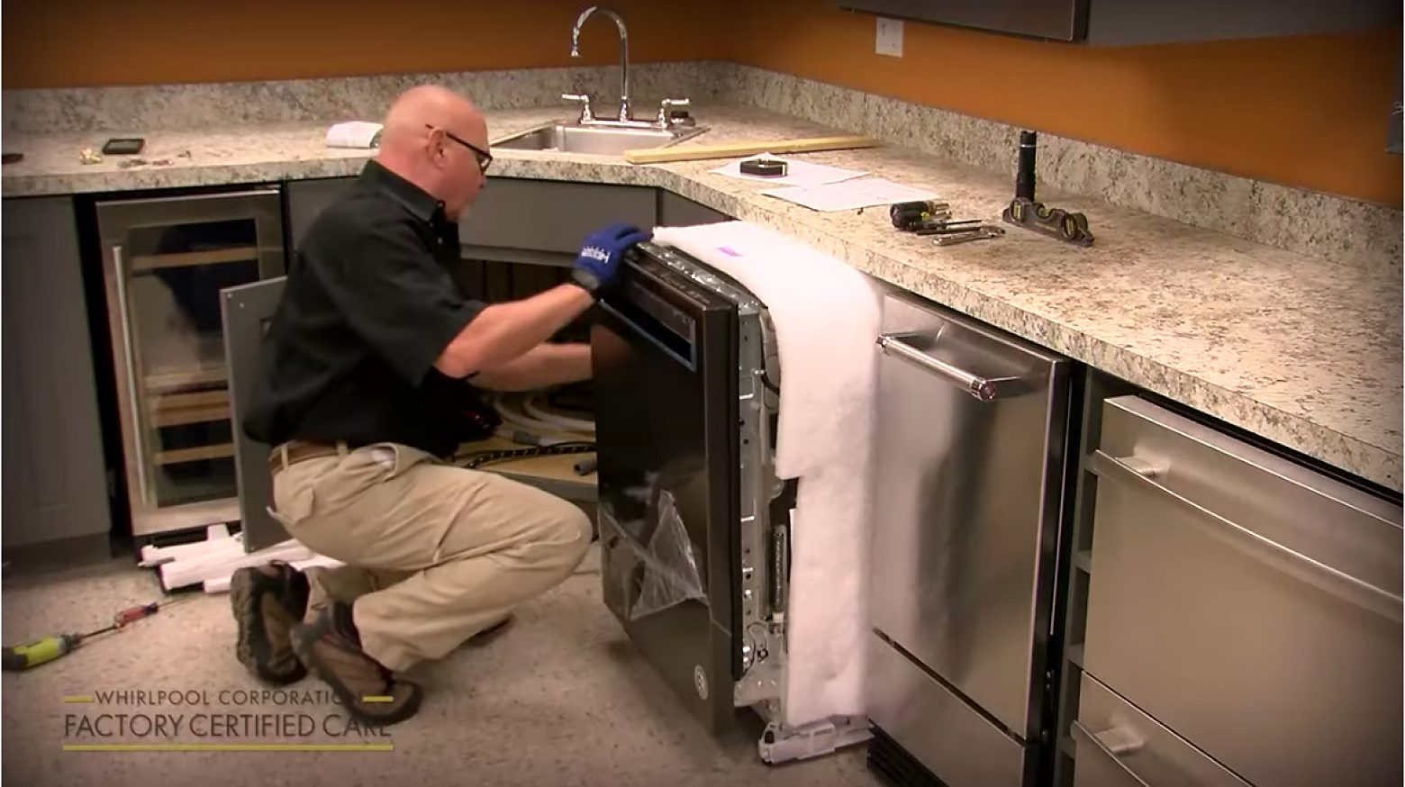 Person installing a new dishwasher