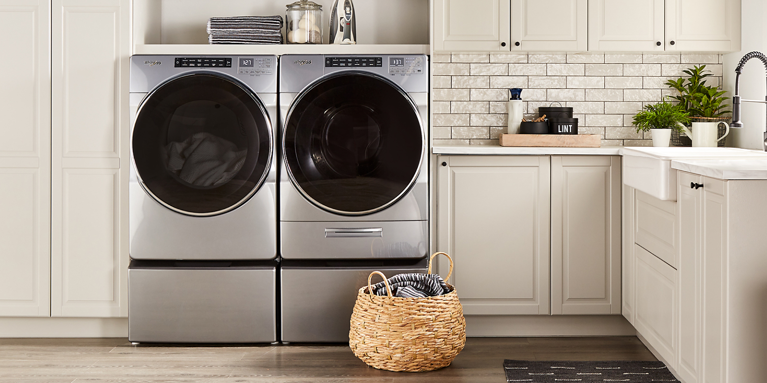 A silver Whirlpool® washer and dryer pair in a laundry room