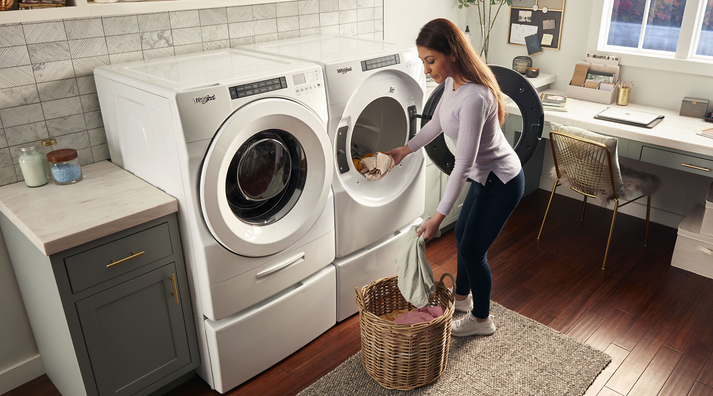 Person loading Whirlpool® dryer
