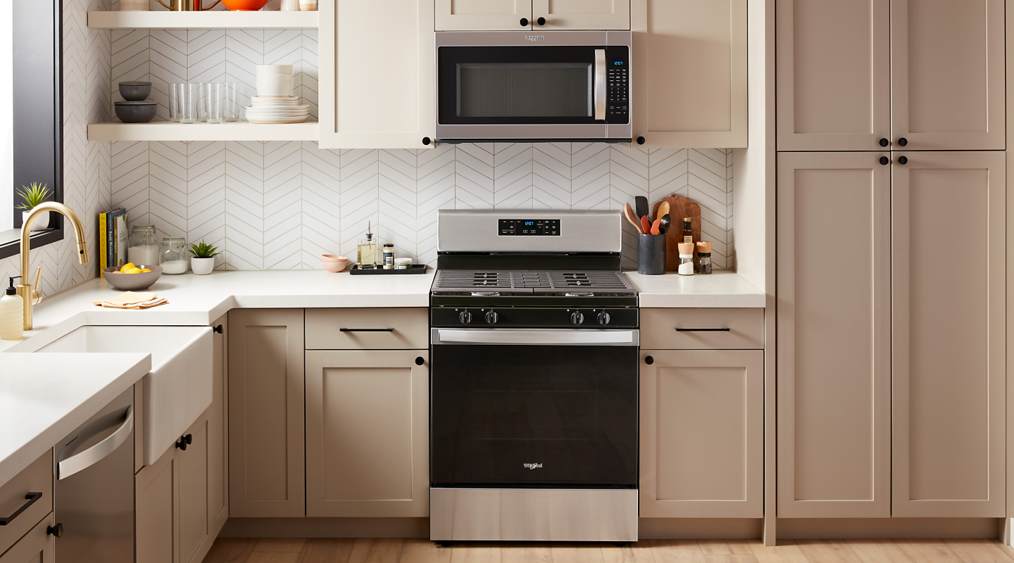 A slide-in range and over-the-range microwave in a modern kitchen