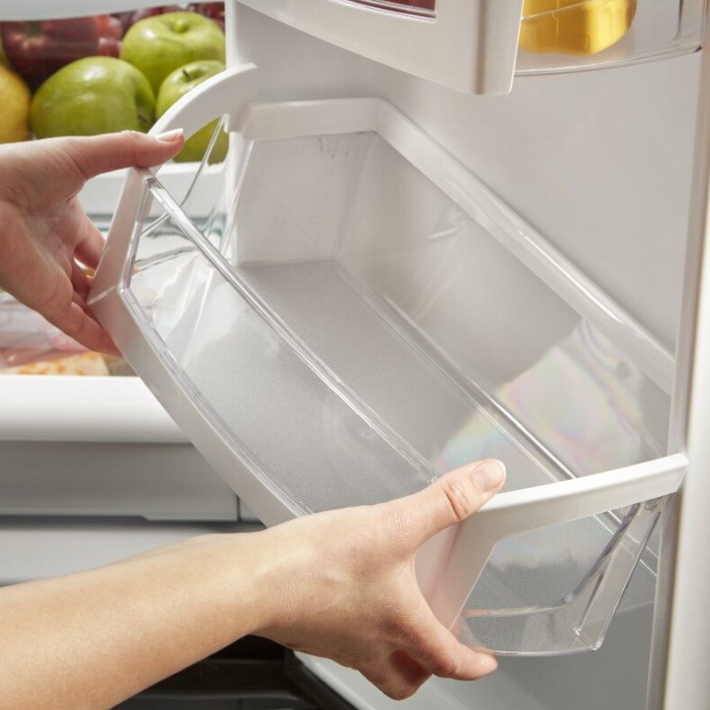 Person removing a shelf from the fridge