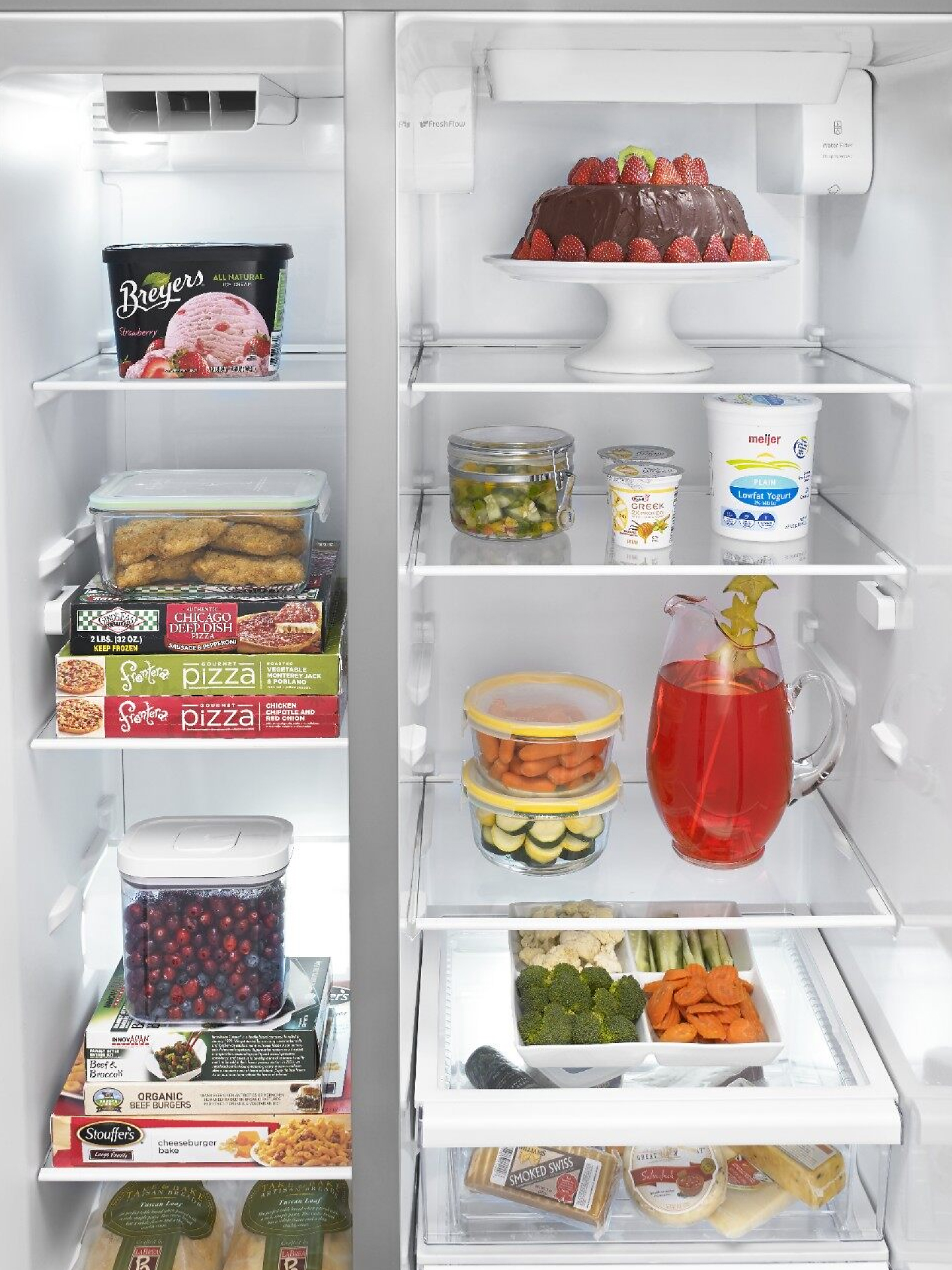 View of side-to-side freezer and fridge compartments with food 