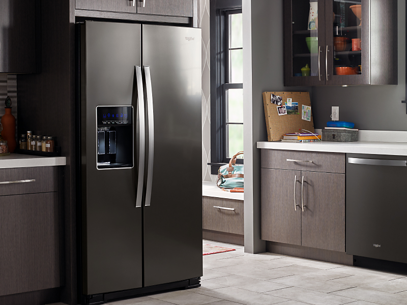 A stainless steel Whirlpool® side-by-side fridge in a kitchen