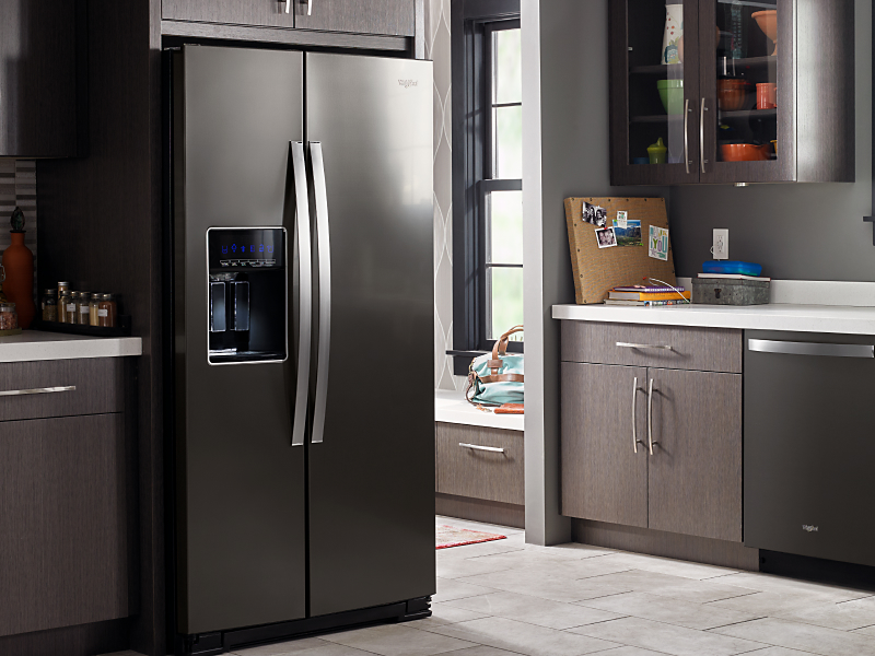 A stainless steel Whirlpool® side-by-side fridge in a kitchen A stainless steel Whirlpool® side-by-side fridge in a kitchen