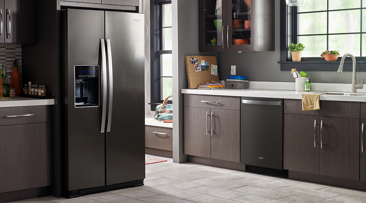A stainless steel Whirlpool® side-by-side fridge in a kitchen A stainless steel Whirlpool® side-by-side fridge in a kitchen