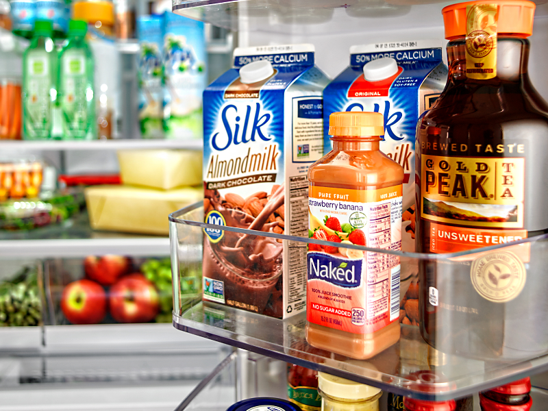 Various beverages stored in a fridge door bin Various beverages stored in a fridge door bin
