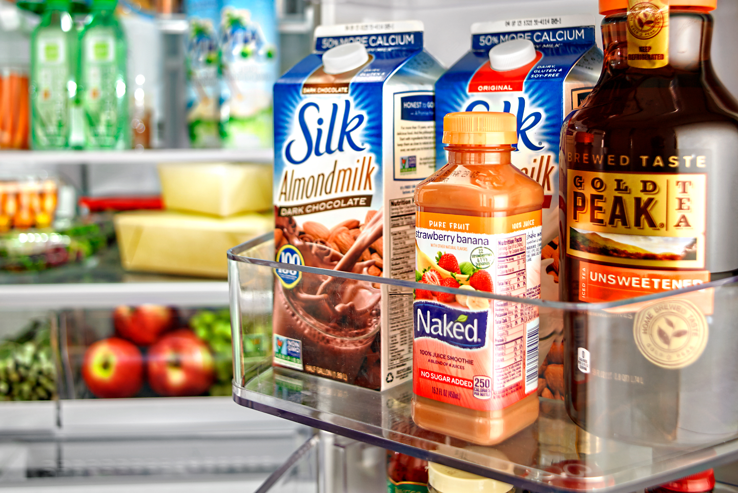 Various beverages stored in a fridge door bin Various beverages stored in a fridge door bin