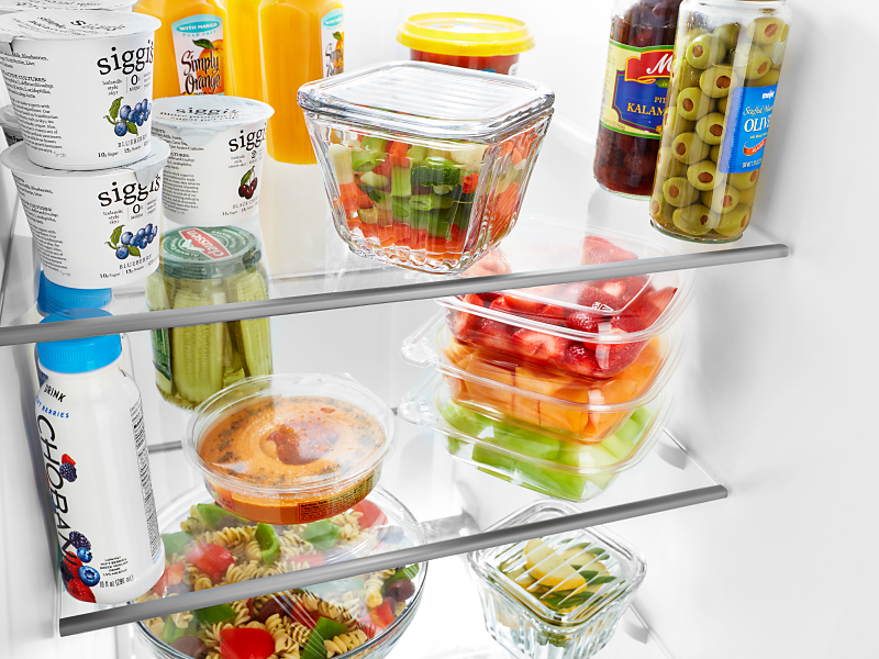 Food items and ingredients stored on a fridge shelf Food items and ingredients stored on a fridge shelf