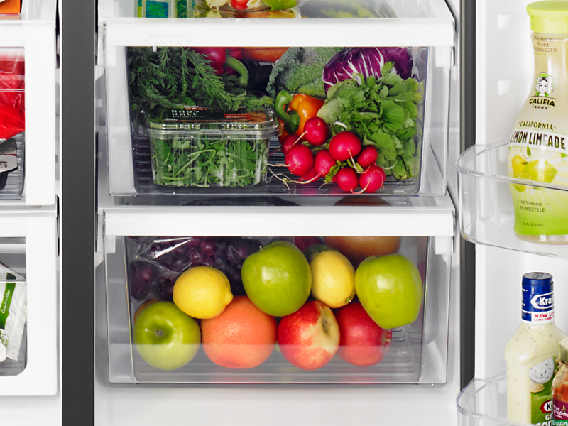 Fresh fruits and vegetables stored in a fridge crisper drawer