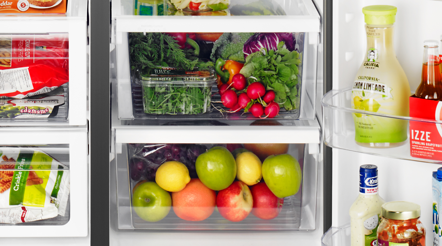 Fresh fruits and vegetables stored in a fridge crisper drawer Fresh fruits and vegetables stored in a fridge crisper drawer