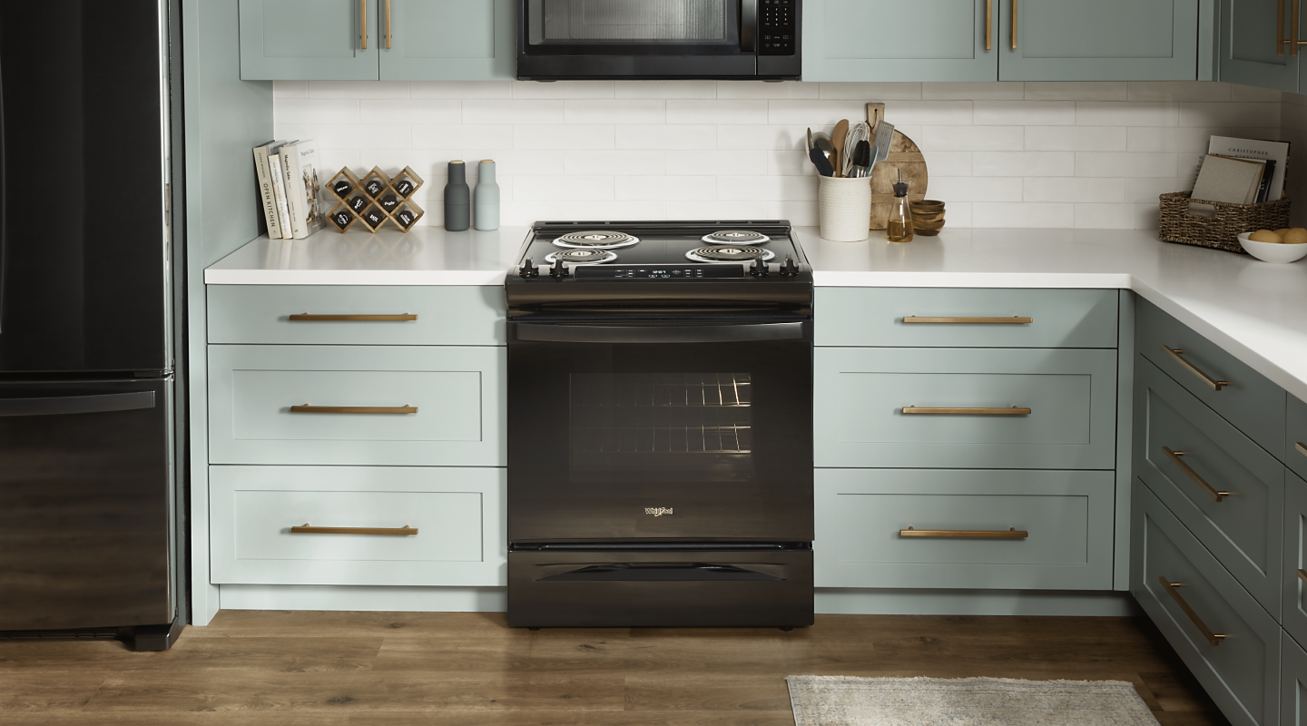 A Whirlpool® electric cooktop with coil burners in a modern kitchen.