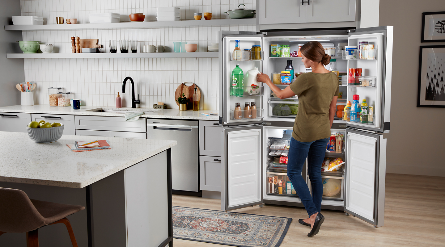 Person removing things from a 4-door refrigerator