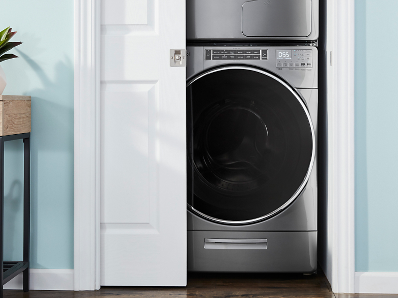 A front load washer in an open closet