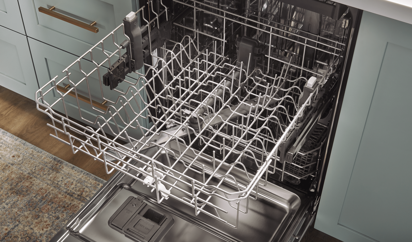 An open dishwasher with an empty top rack extended
