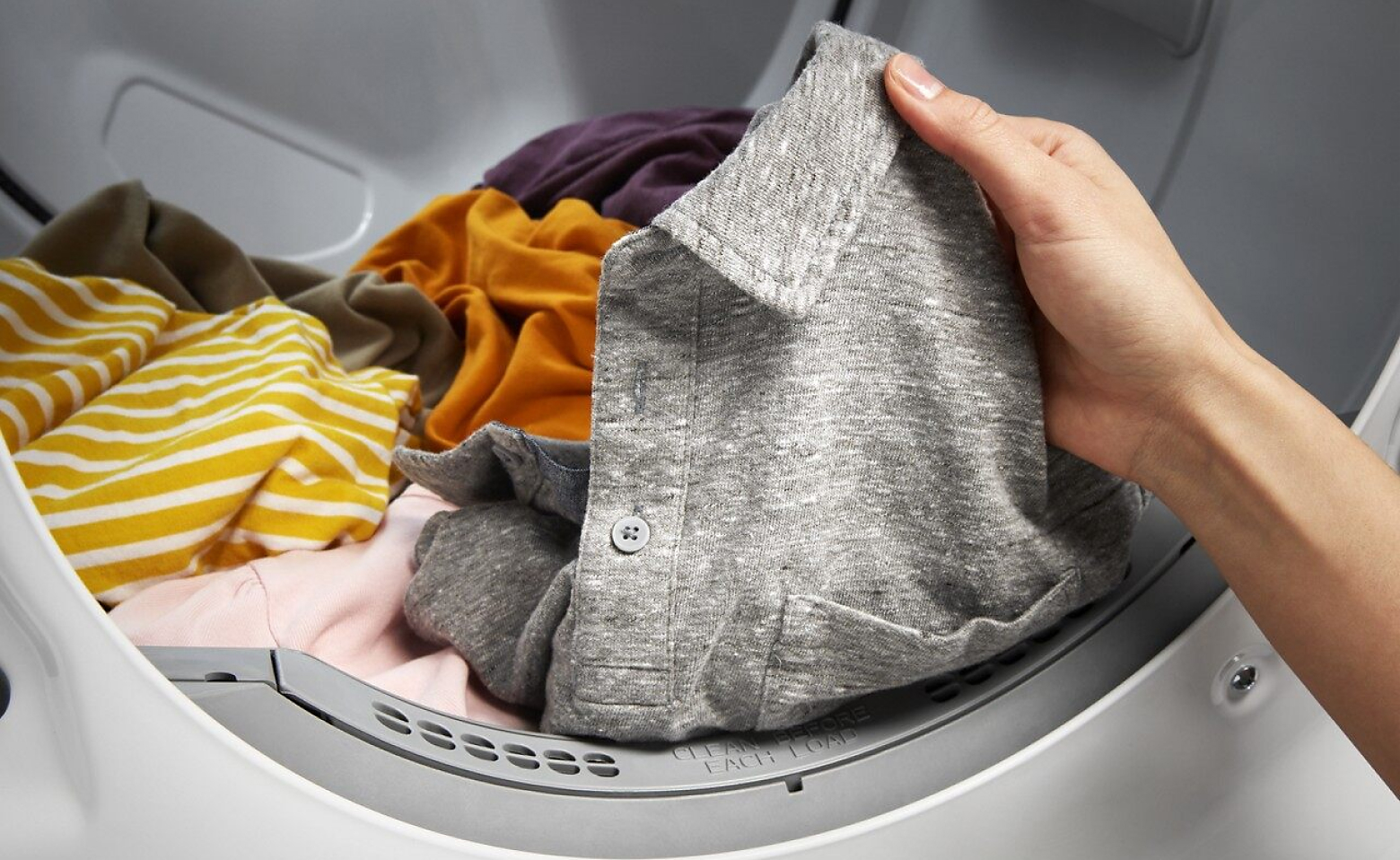 Hand removing clothes from the dryer 