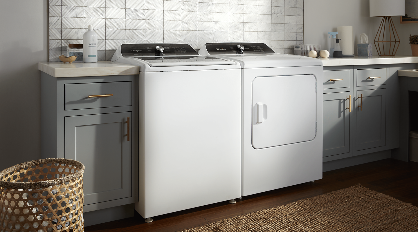 A white Whirlpool® washer and dryer pair in a modern laundry room