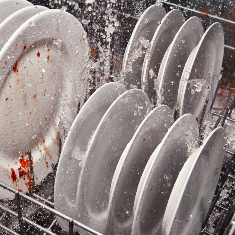 Dirty dishes washing in a Whirlpool® dishwasher.