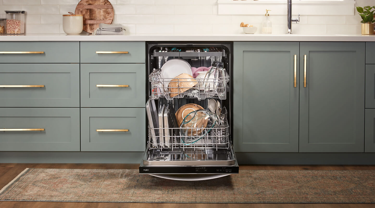Open 3rd rack dishwasher loaded full of dishes in gray-blue cabinetry