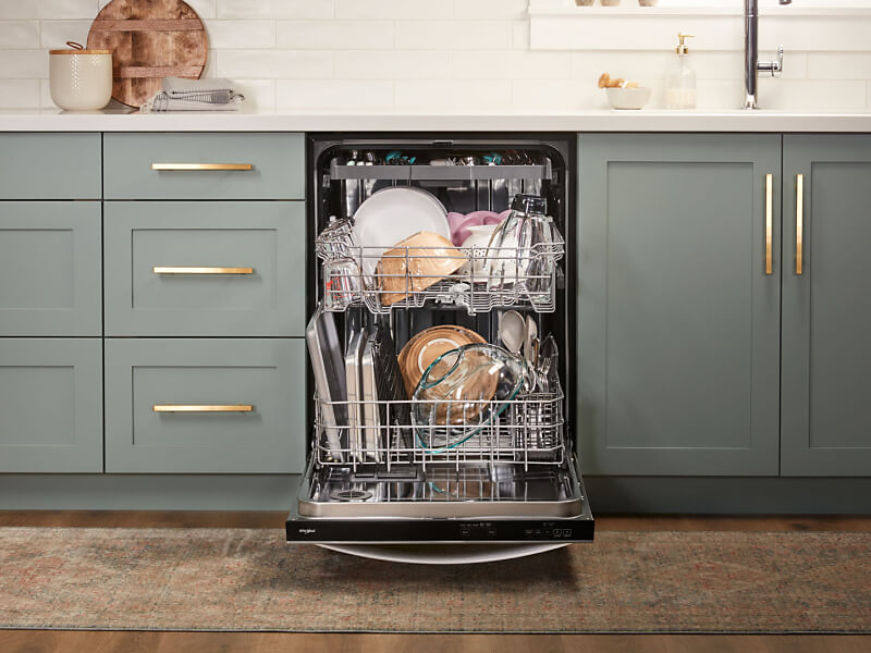 Open 3rd rack dishwasher loaded full of dishes in gray-blue cabinetry