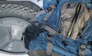 Backpack placed near the interior of a washing machine