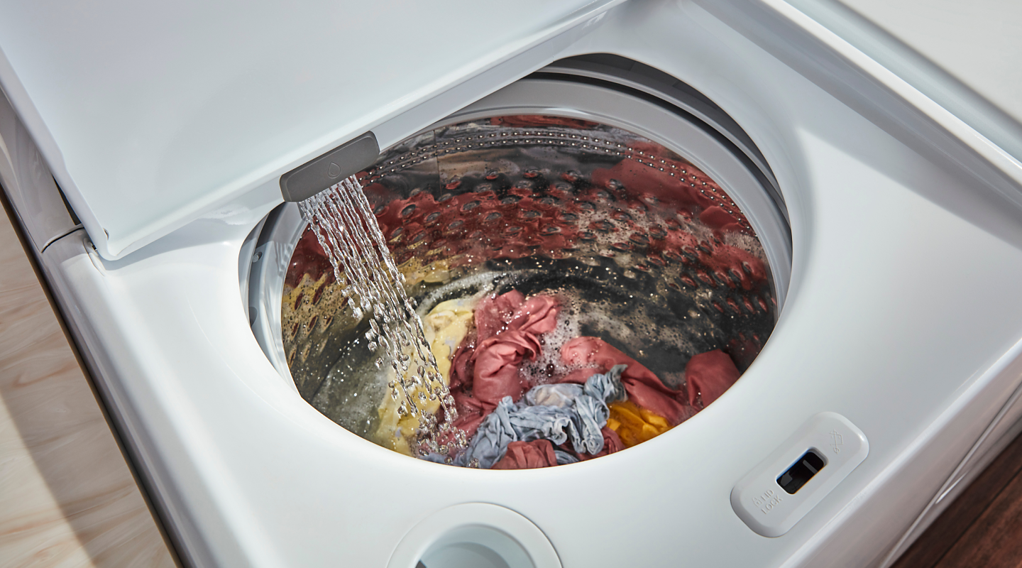 Water pouring into a full top-loading washer