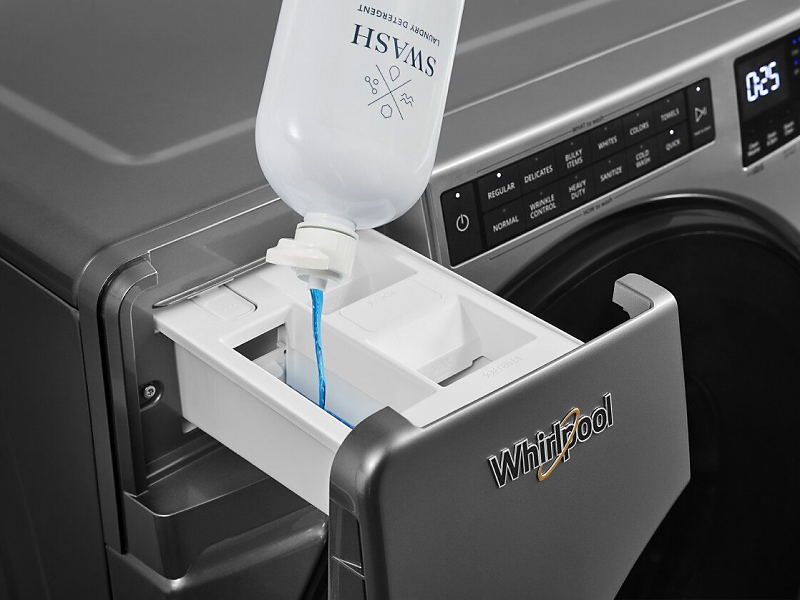 Swash detergent being poured into Whirlpool washer’s detergent dispenser.