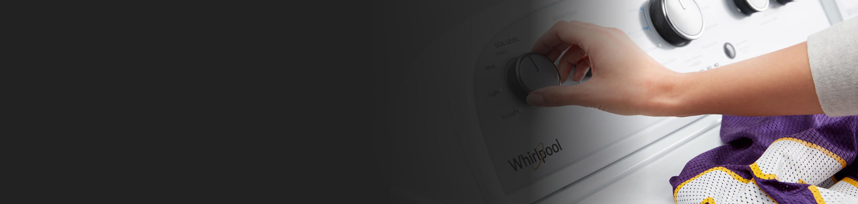 A person adjusting Whirlpool washer’s settings