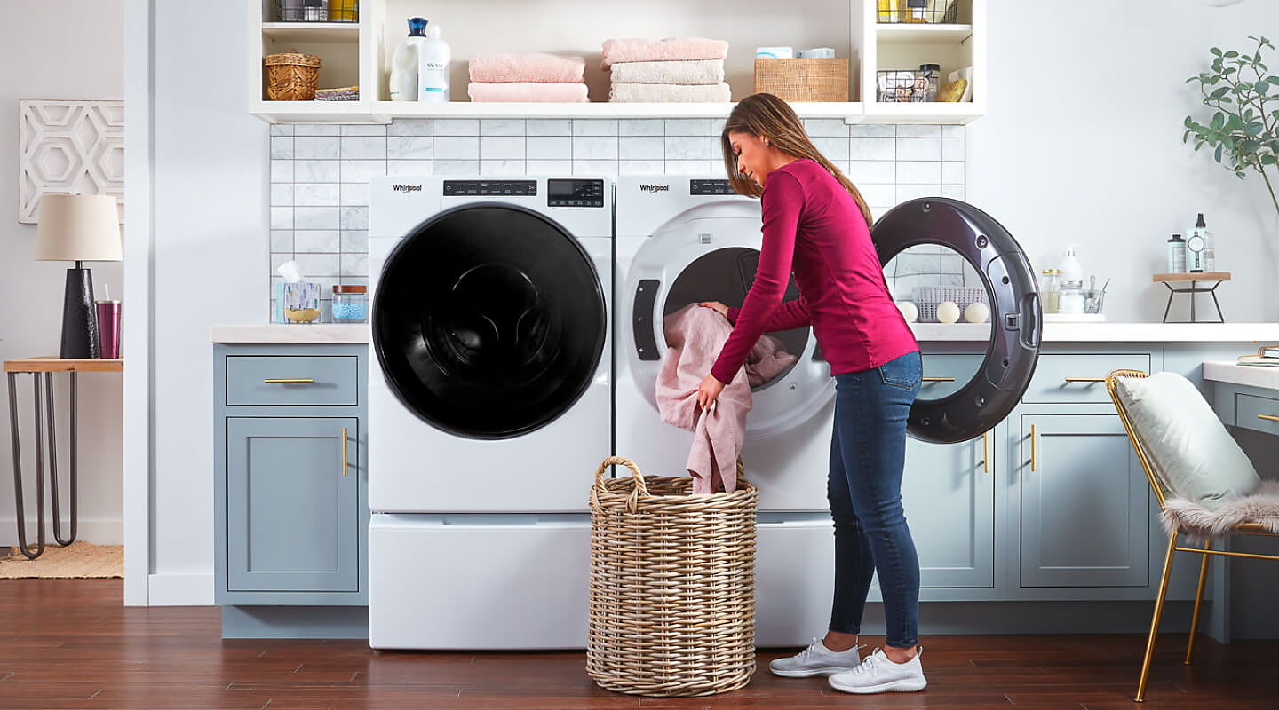 Person putting clothes in Whirlpool® washer