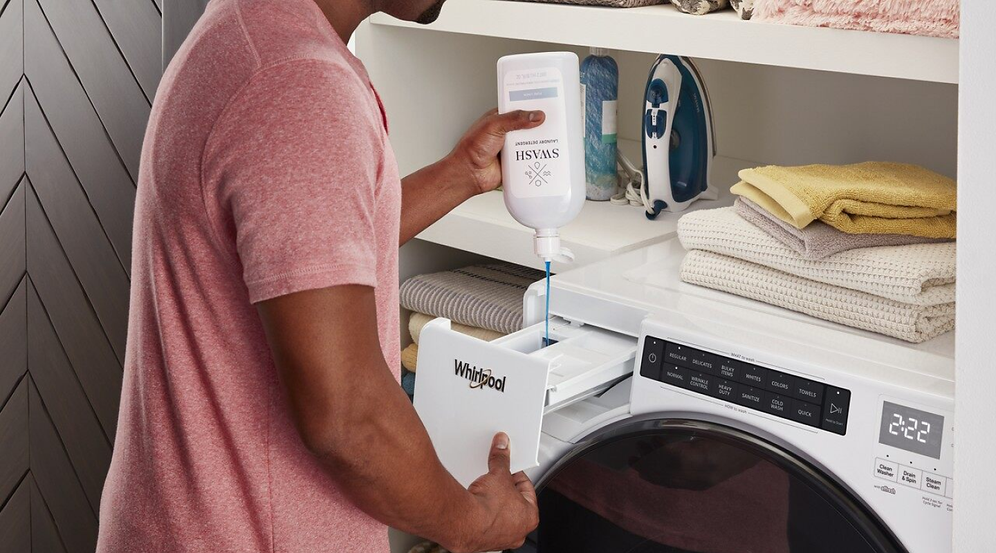 Pouring laundry detergent into the laundry dispenser