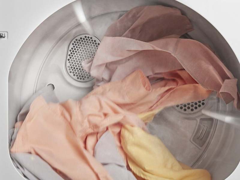 A closeup of laundry tumble drying in a Whirlpool® dryer.