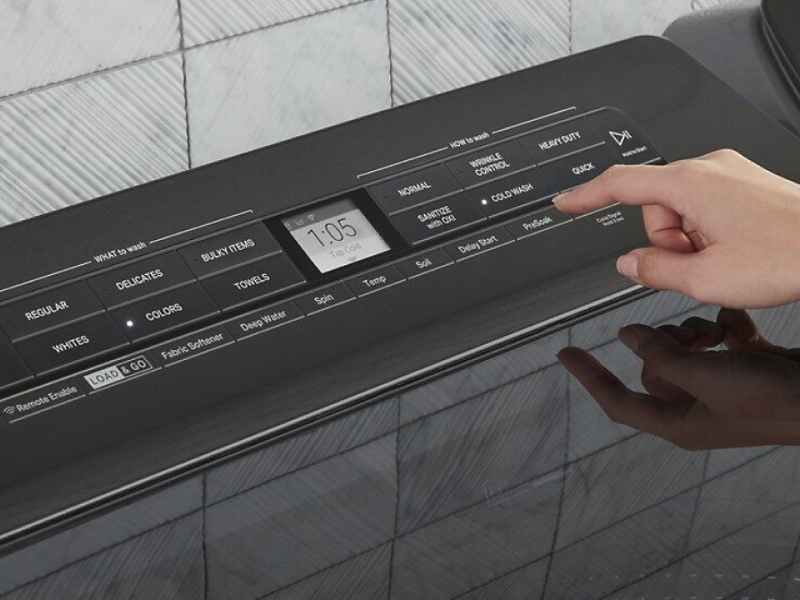 A woman programming the settings of a Whirlpool® dryer panel A woman programming the settings of a Whirlpool® dryer panel