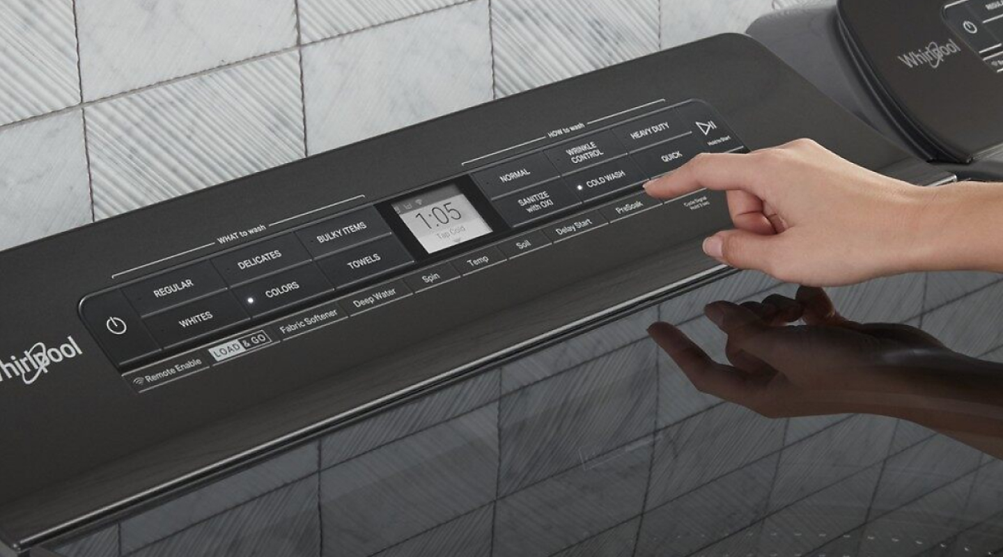 A woman programming the settings of a Whirlpool® dryer panel A woman programming the settings of a Whirlpool® dryer panel