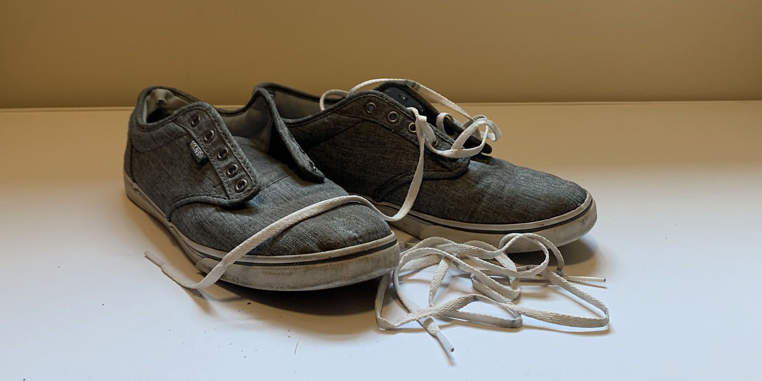 Dirty shoes with shoe laces removed.