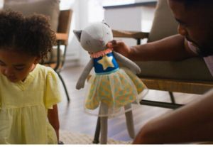 Father and daughter playing
with a clean stuffed animal