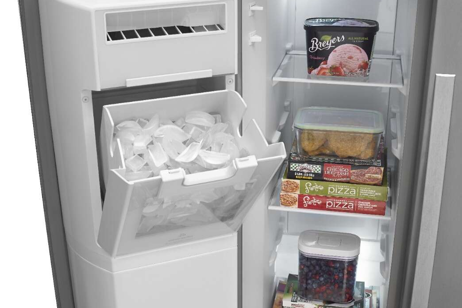Open freezer door in side-by-side refrigerator revealing open, in-door ice maker