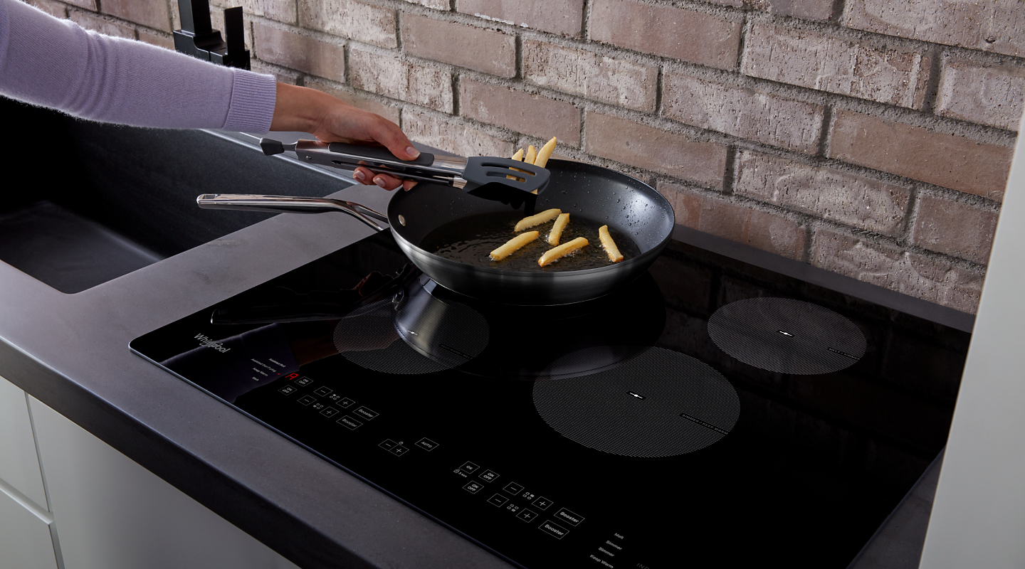 Fries cooking on an induction cooktop